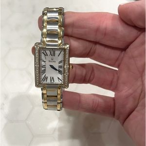 Women’s Bulova watch. Mother of pearl face, stainless steel and gold band.